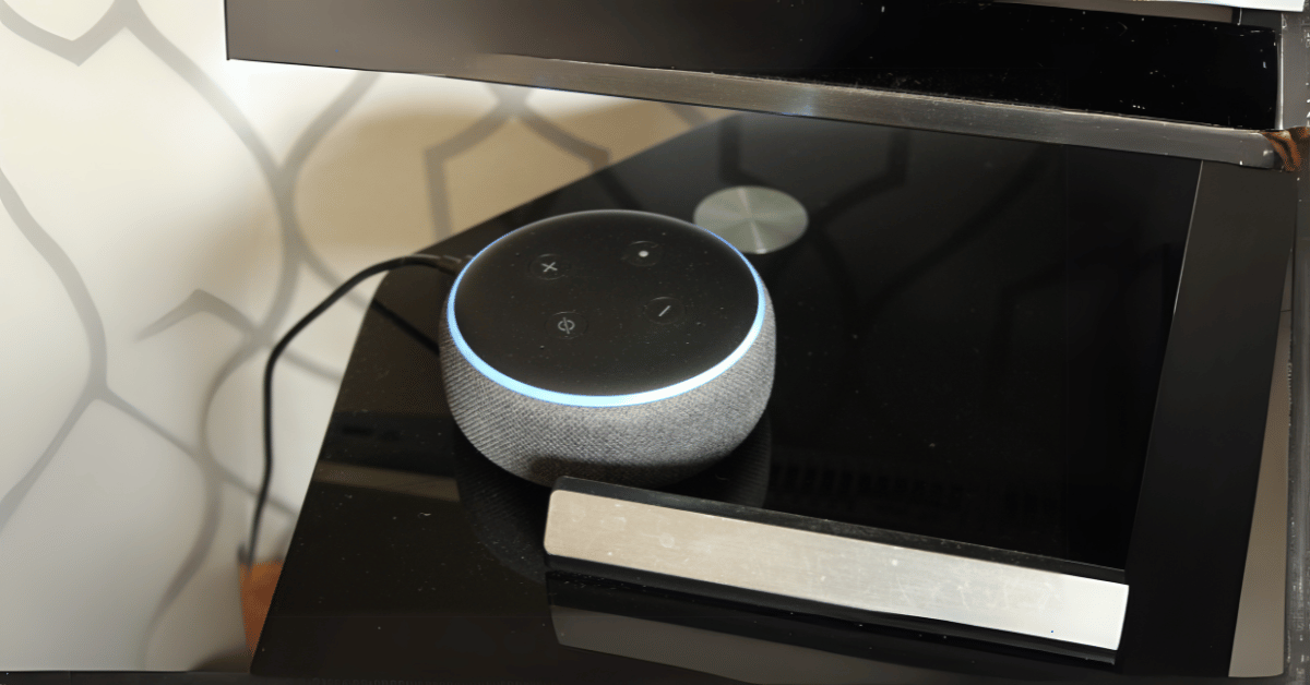 An Alexa Echo Dot on a table.