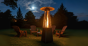 Outdoor heater with chairs and table on a lawn at night.